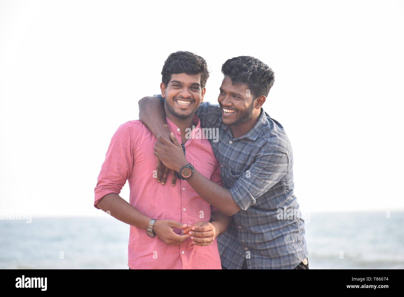 Best Friends laughing in seashore Stock Photo