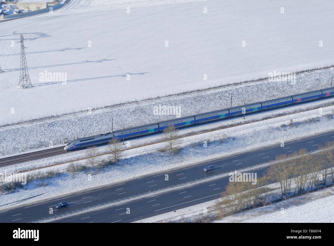 France, Seine et Marne, lines of TGV (HST) and highway A5, in winter (aerial view) Stock Photo