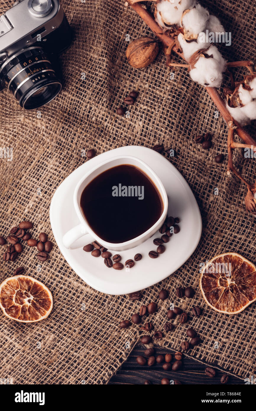 Coffee and cotton retro camera on sacking Still life with the top view Stock Photo