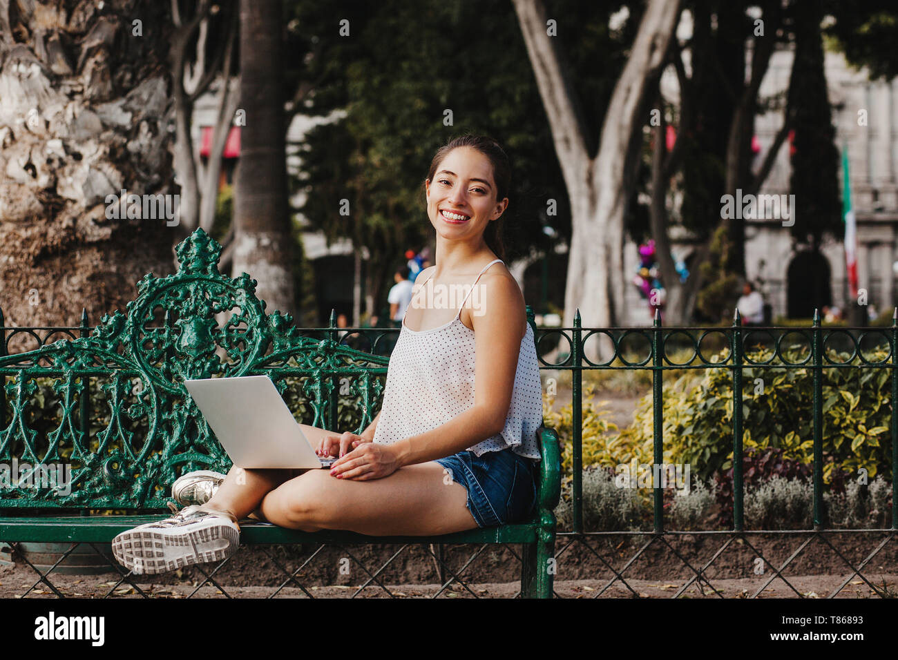 Latin Woman holding a laptop and smiling in Mexico, mexican girl Stock Photo