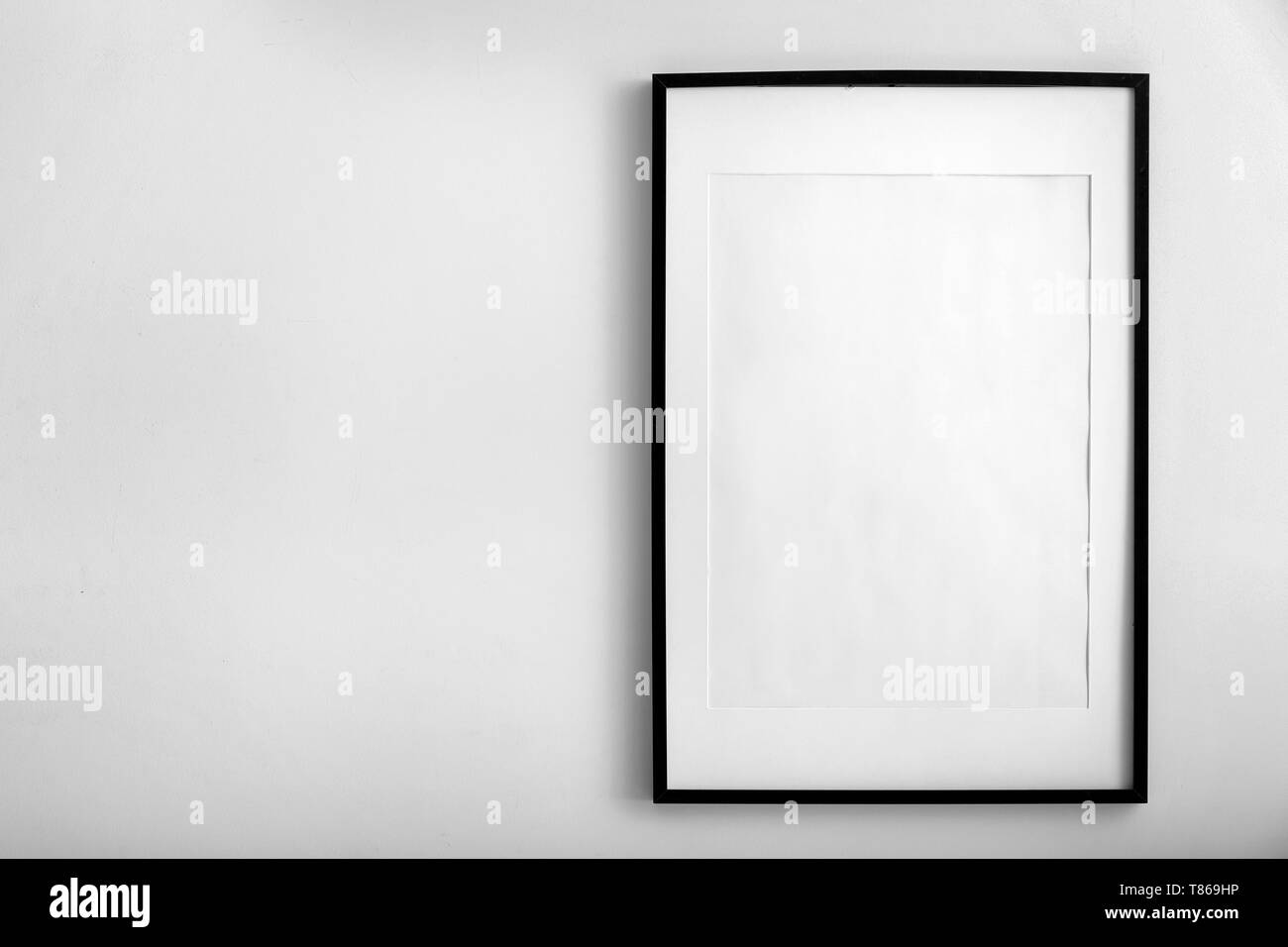 Blank photo frame hanging on white wall Stock Photo Alamy