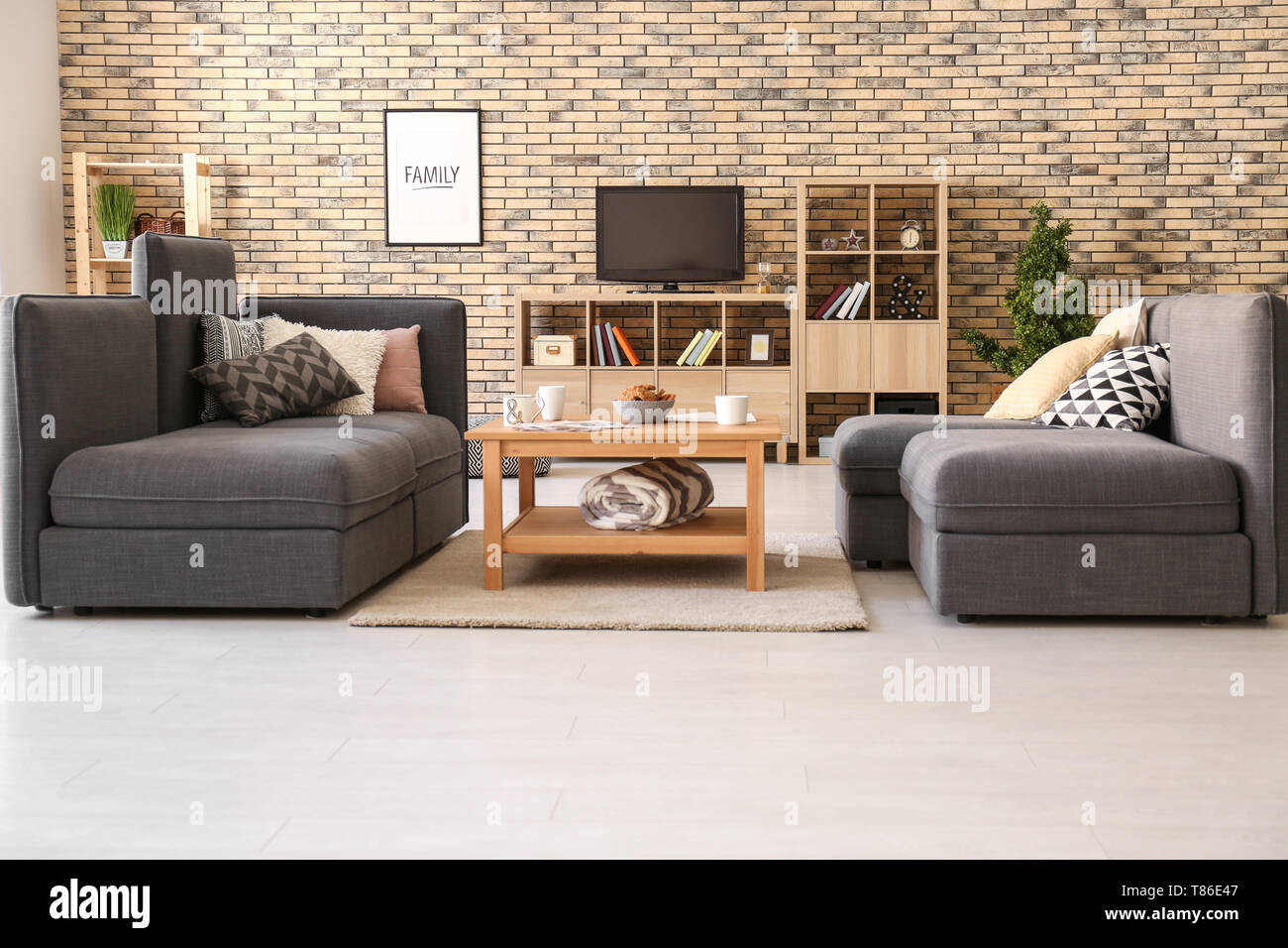 Stylish interior of living room with comfortable sofa Stock Photo - Alamy