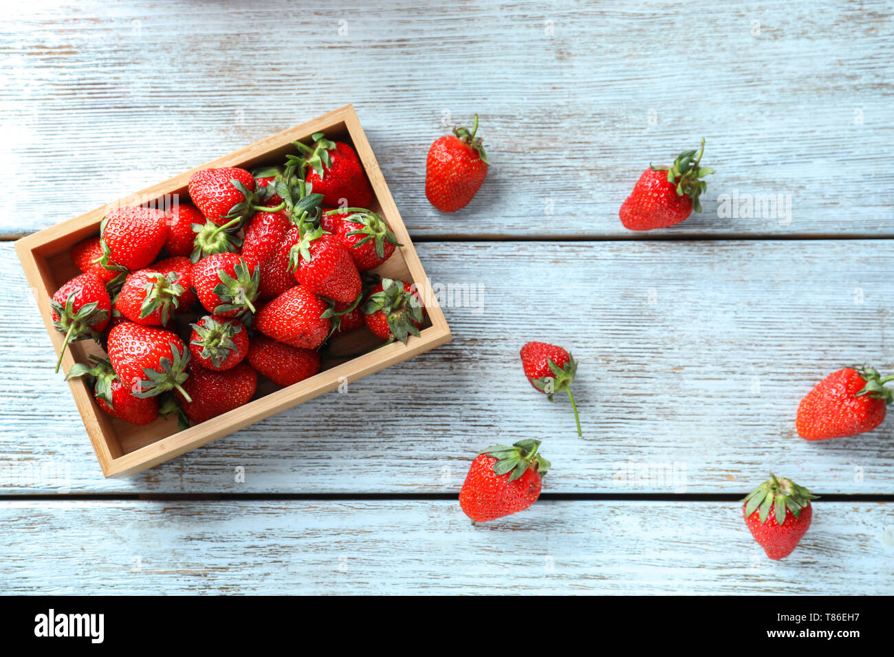 Box with sweet ripe strawberries on wooden table Stock Photo - Alamy