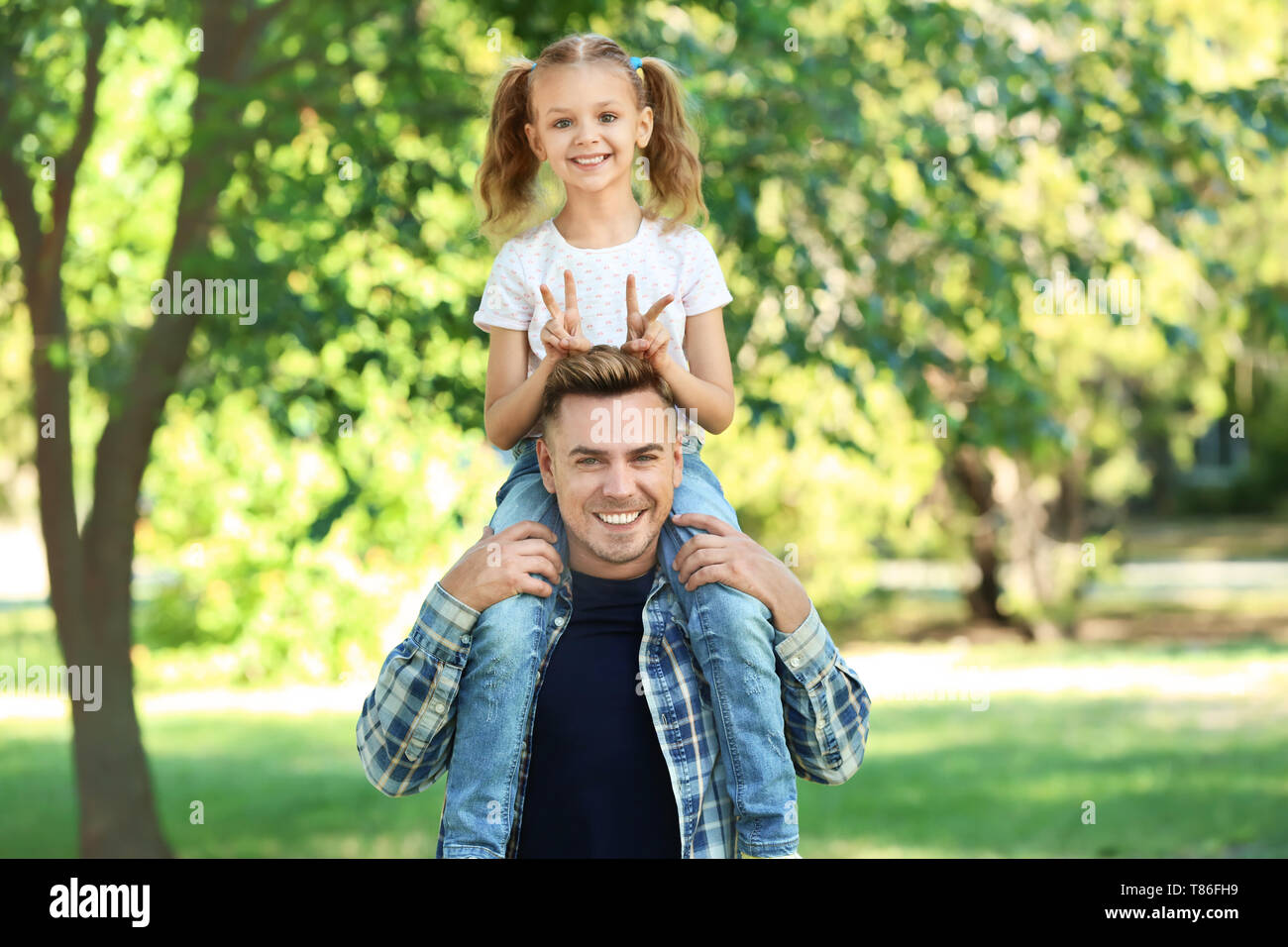 Portrait of happy father and daughter in green park Stock Photo - Alamy