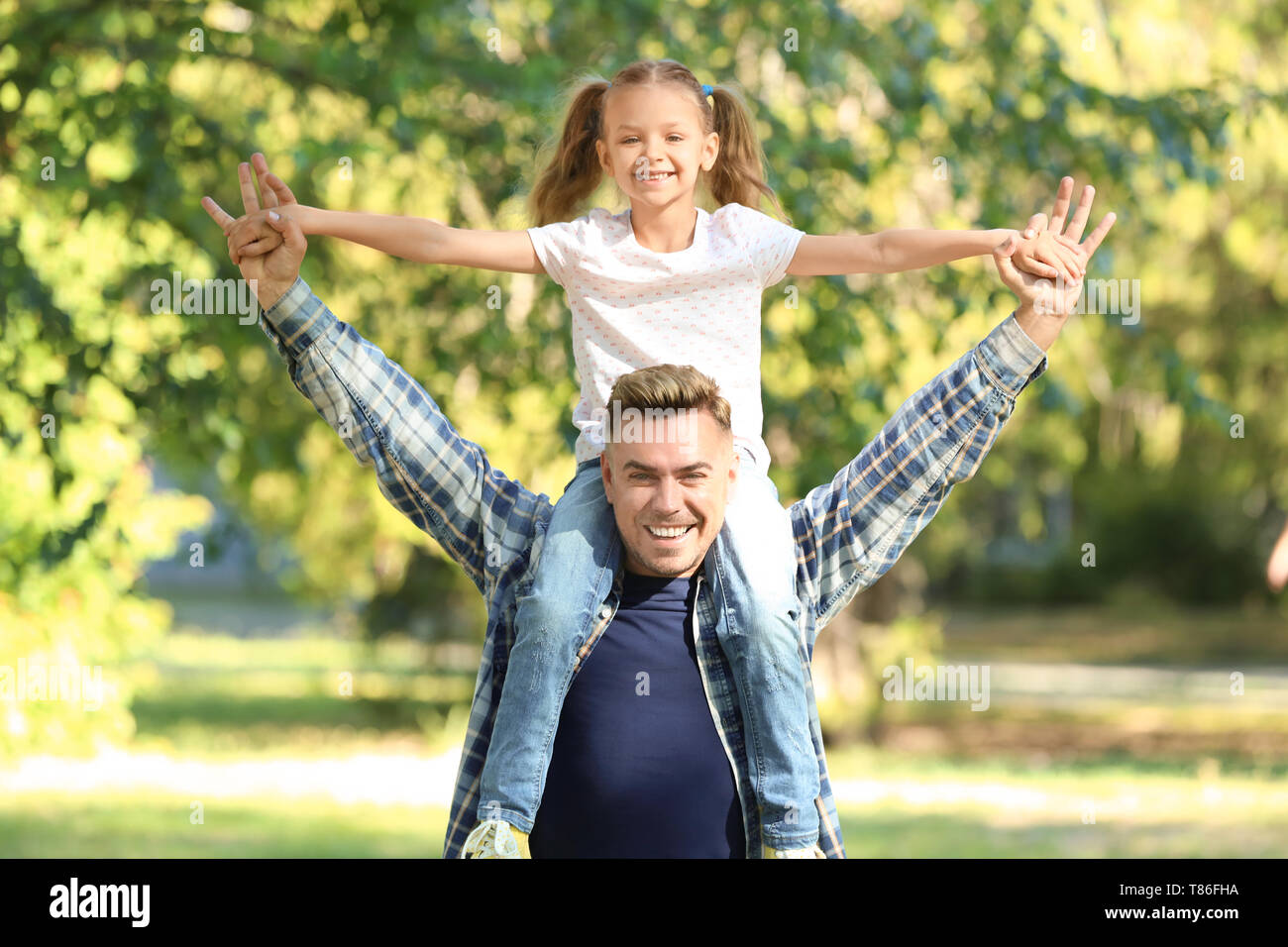 Portrait of happy father and daughter in green park Stock Photo - Alamy