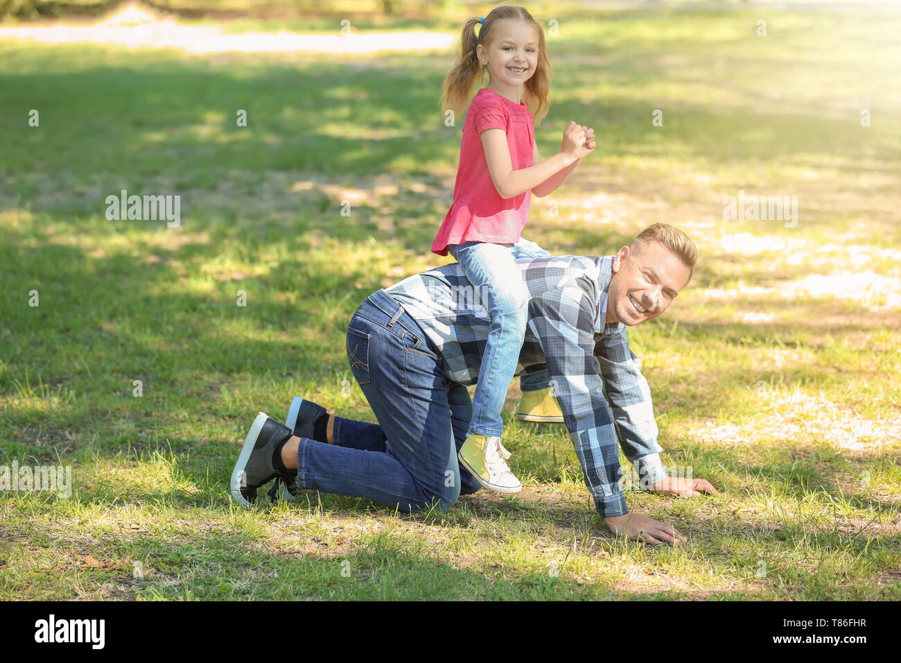 Happy father and daughter playing in green park Stock Photo - Alamy