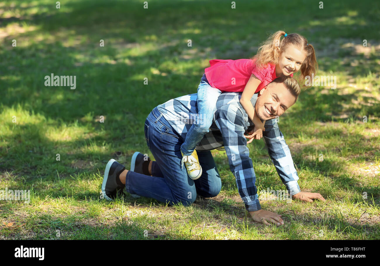 Happy father and daughter playing in green park Stock Photo - Alamy