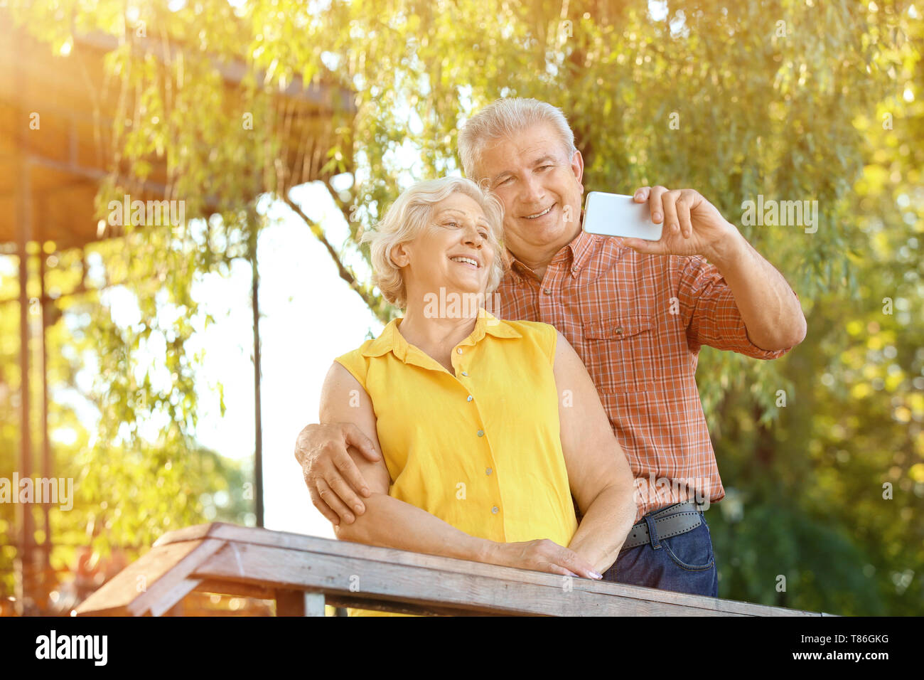 Happy mature couple taking selfie in park Stock Photo