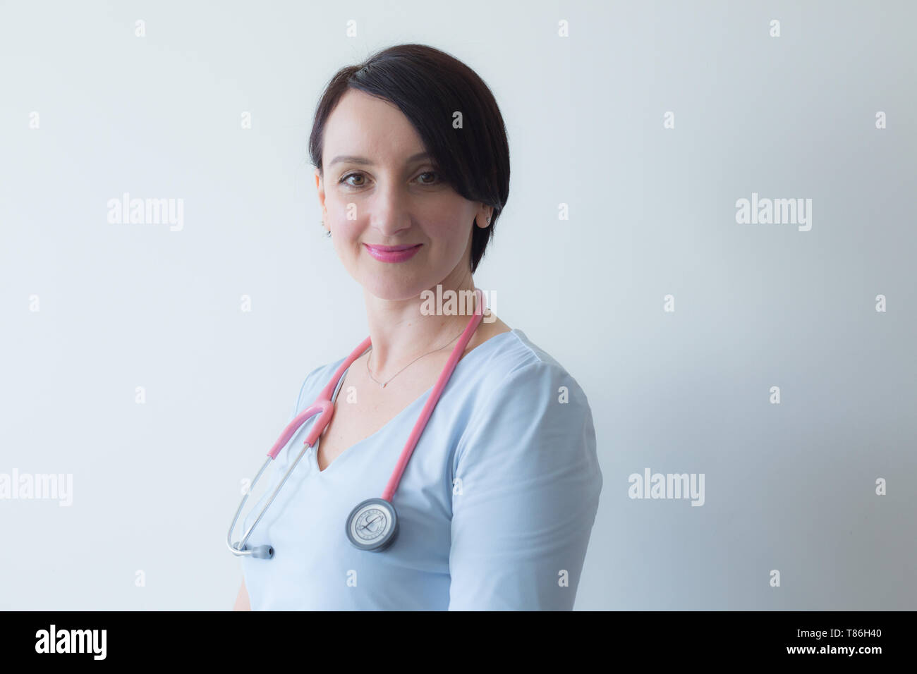 Doctor female portrait  stethoscope light blue uniform  Stock Photo