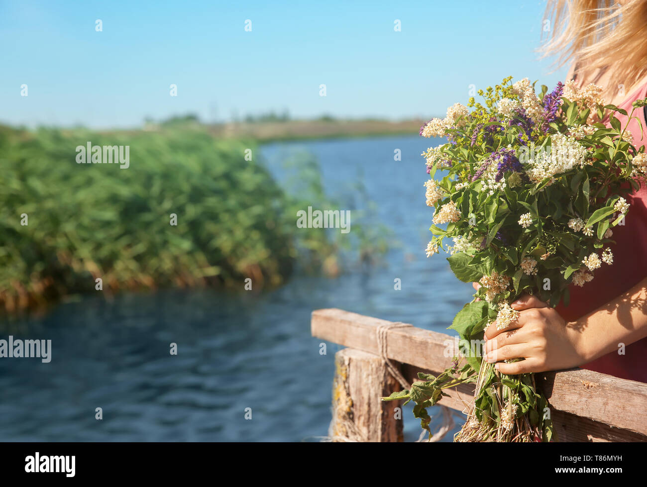 Young woman holding bouquet of beautiful flowers outdoors Stock Photo ...