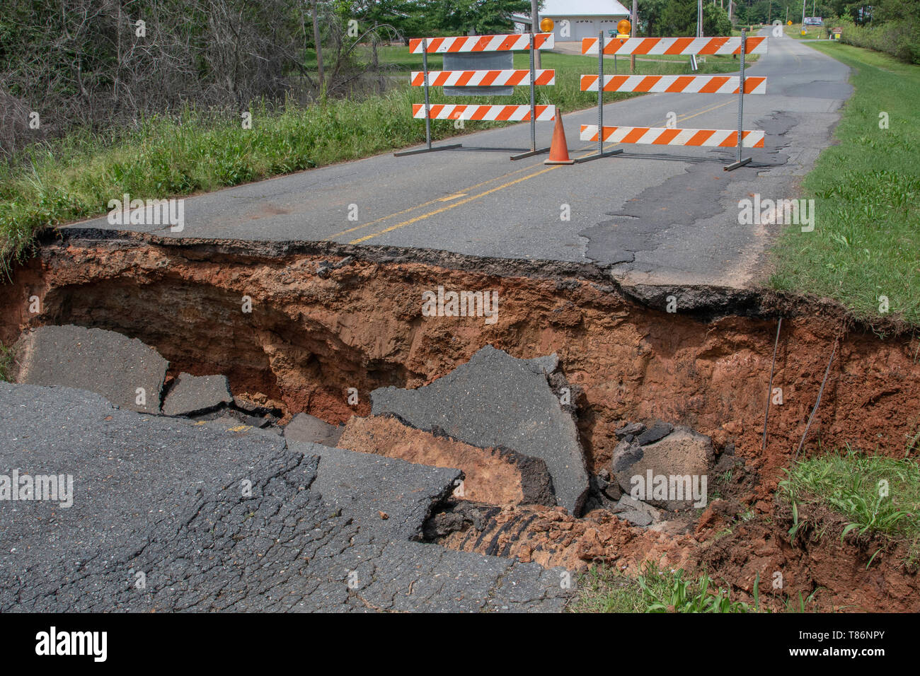 BOSSIER PARISH, LA., U.S.A. - MAY 9, 2019: Following thunderstorms and heavy rains, the ground has washed away and the pavement caved in. Stock Photo