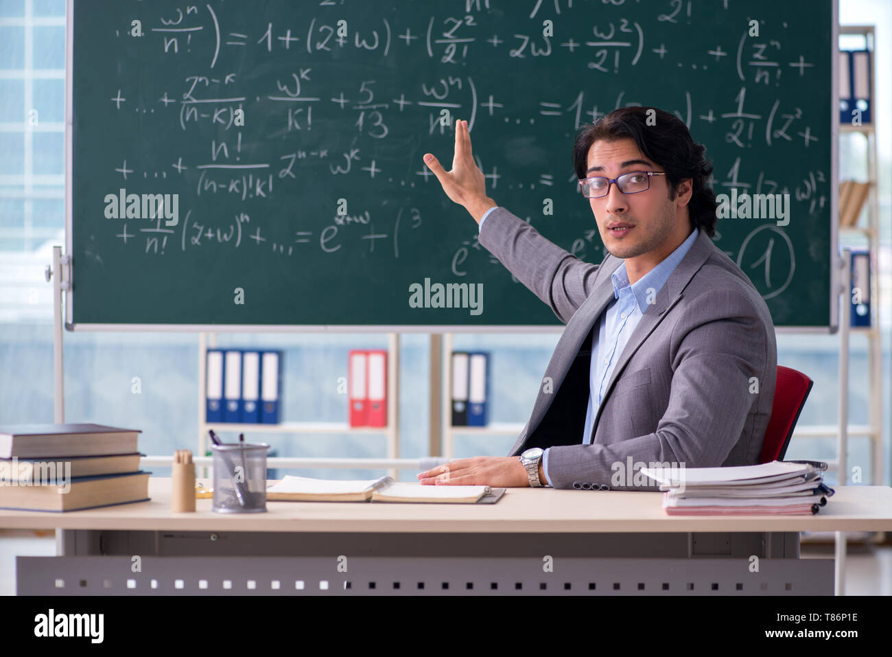 Young handsome math teacher in classroom Stock Photo