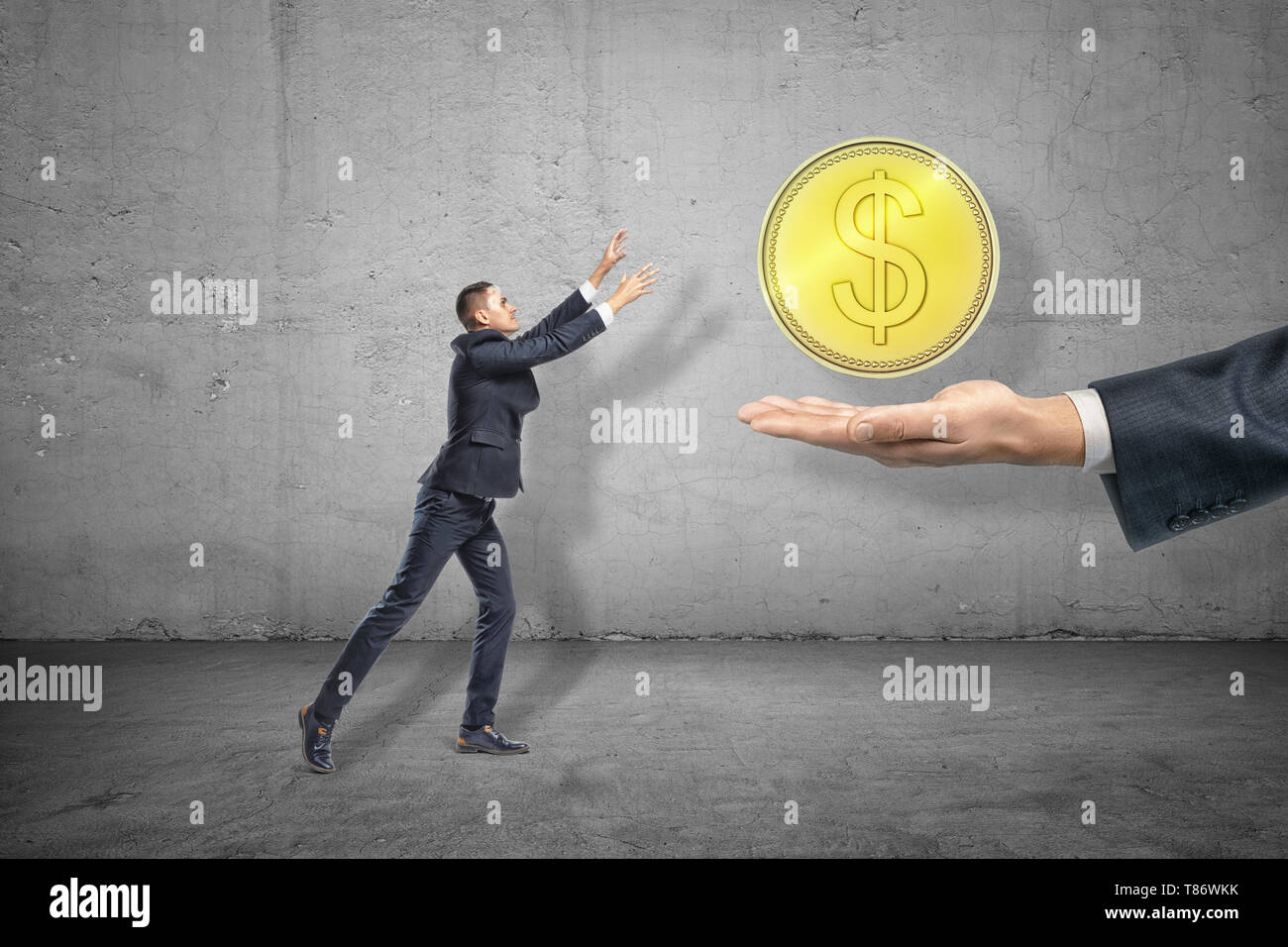 Side full length view of little businessman reaching out for big gold coin levitated above huge hand emerging from right. Stock Photo