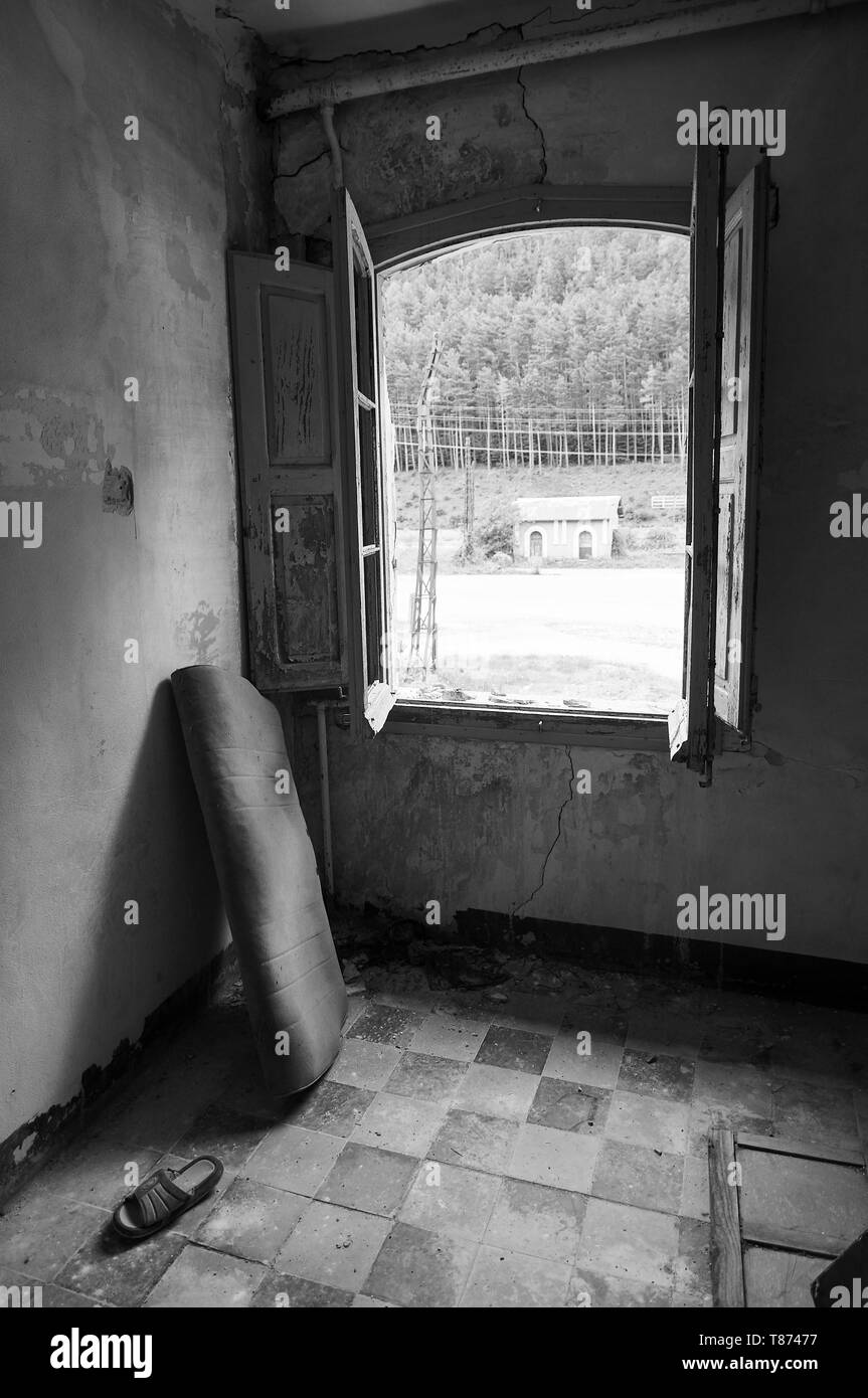 Interior of a room in the ruined facilities at the abandoned Canfranc International railway station (Canfranc, Pyrenees, Huesca,Aragon,Spain) B&W vers Stock Photo