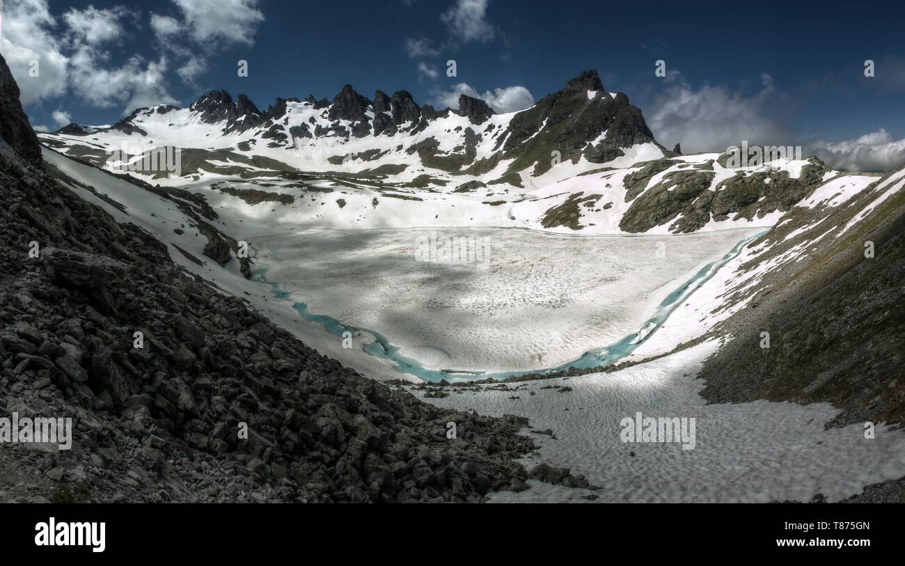 Spring Thaw Walk Wildsee; teal glacial lake on the Pizol 5-lakes walk, during the Spring ...