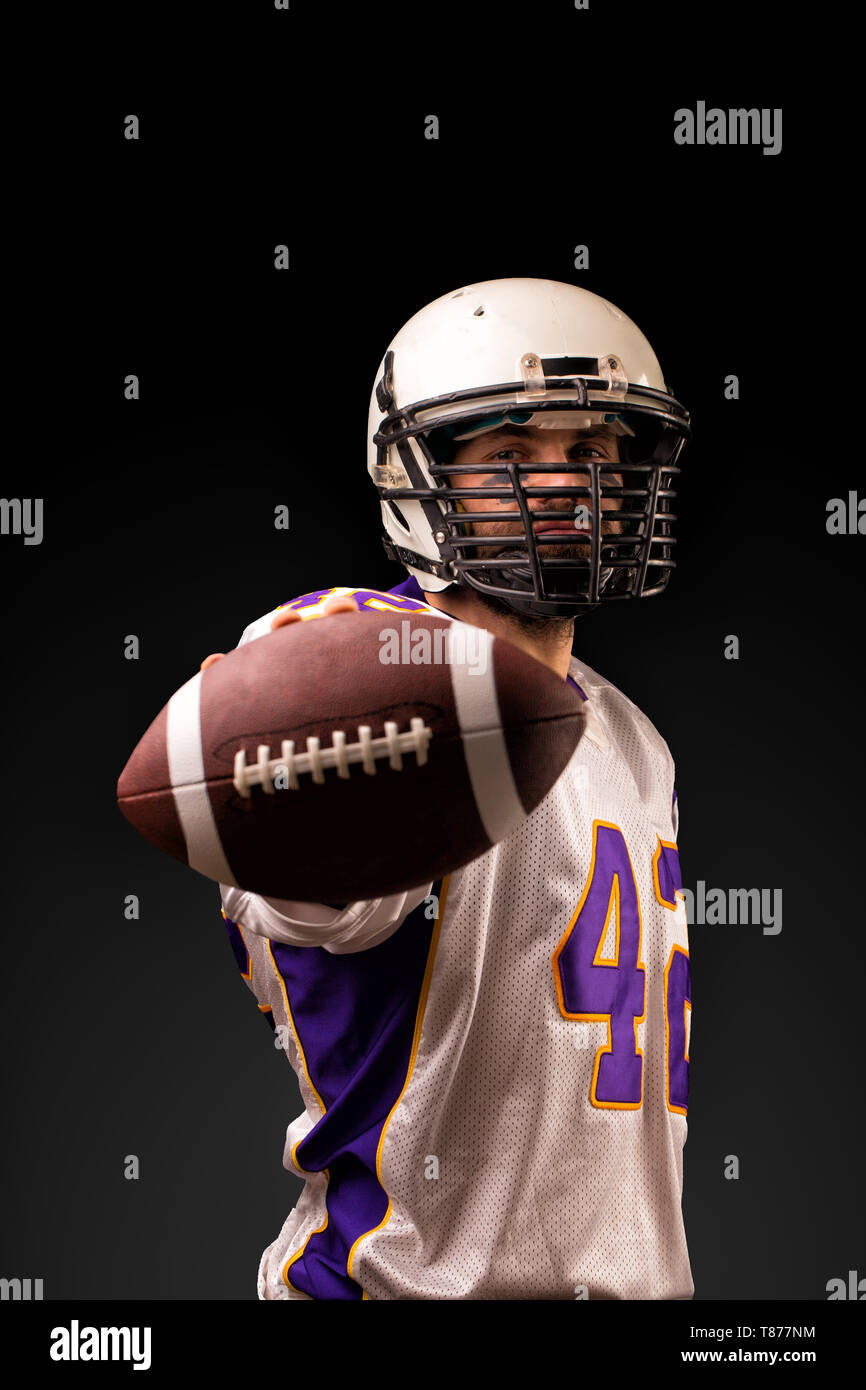 American Football Player Holding The Ball In His Hands In Front Of The Camera Concept American Football Motivation Black Background Stock Photo Alamy