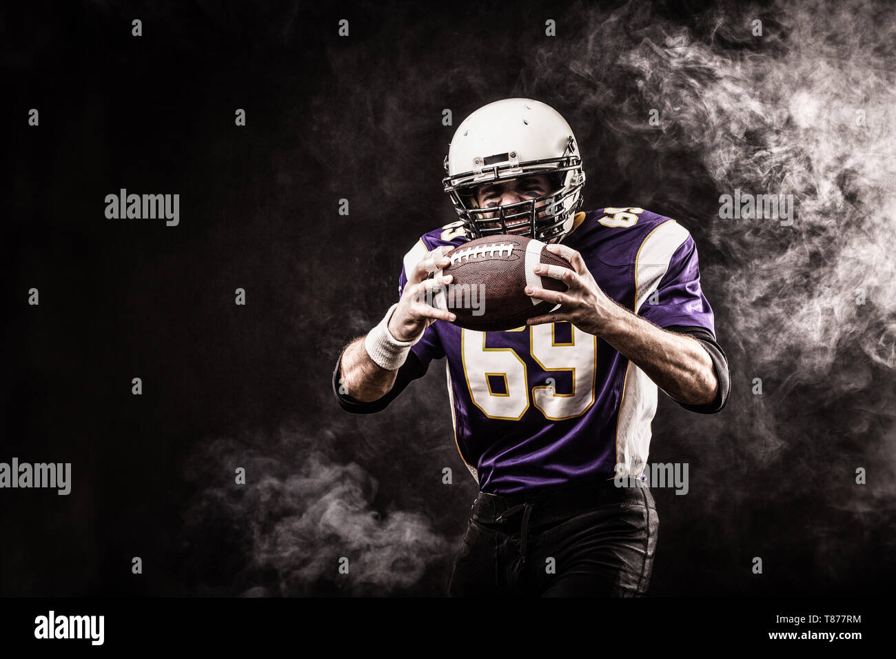 American Football Player Holding Ball In His Hands In Smoke Black Background Copy Space The Concept Of American Football Motivation Copy Space Stock Photo Alamy