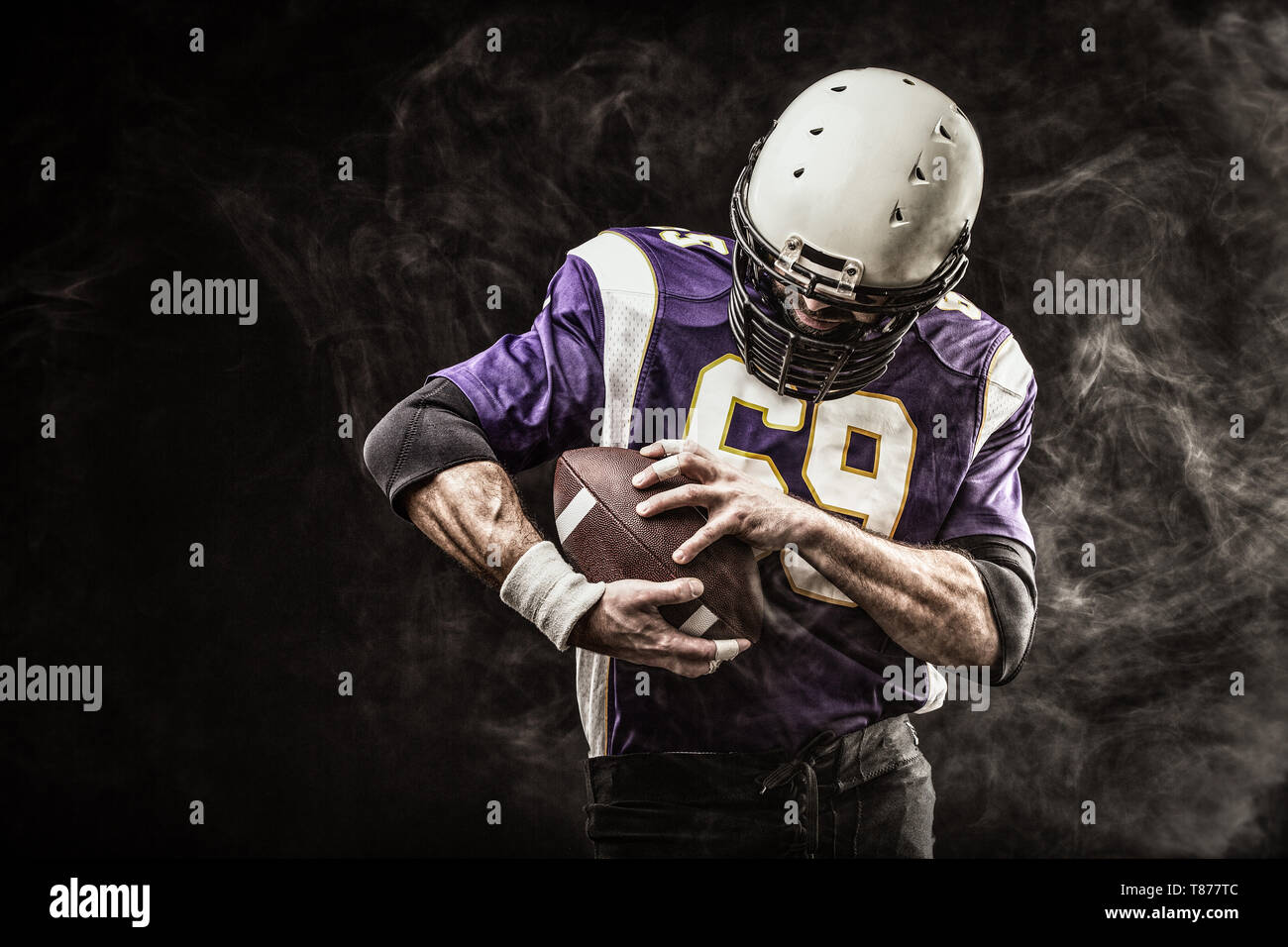 American Football Player Holding Ball In His Hands In Smoke Black Background Copy Space The Concept Of American Football Motivation Copy Space Stock Photo Alamy