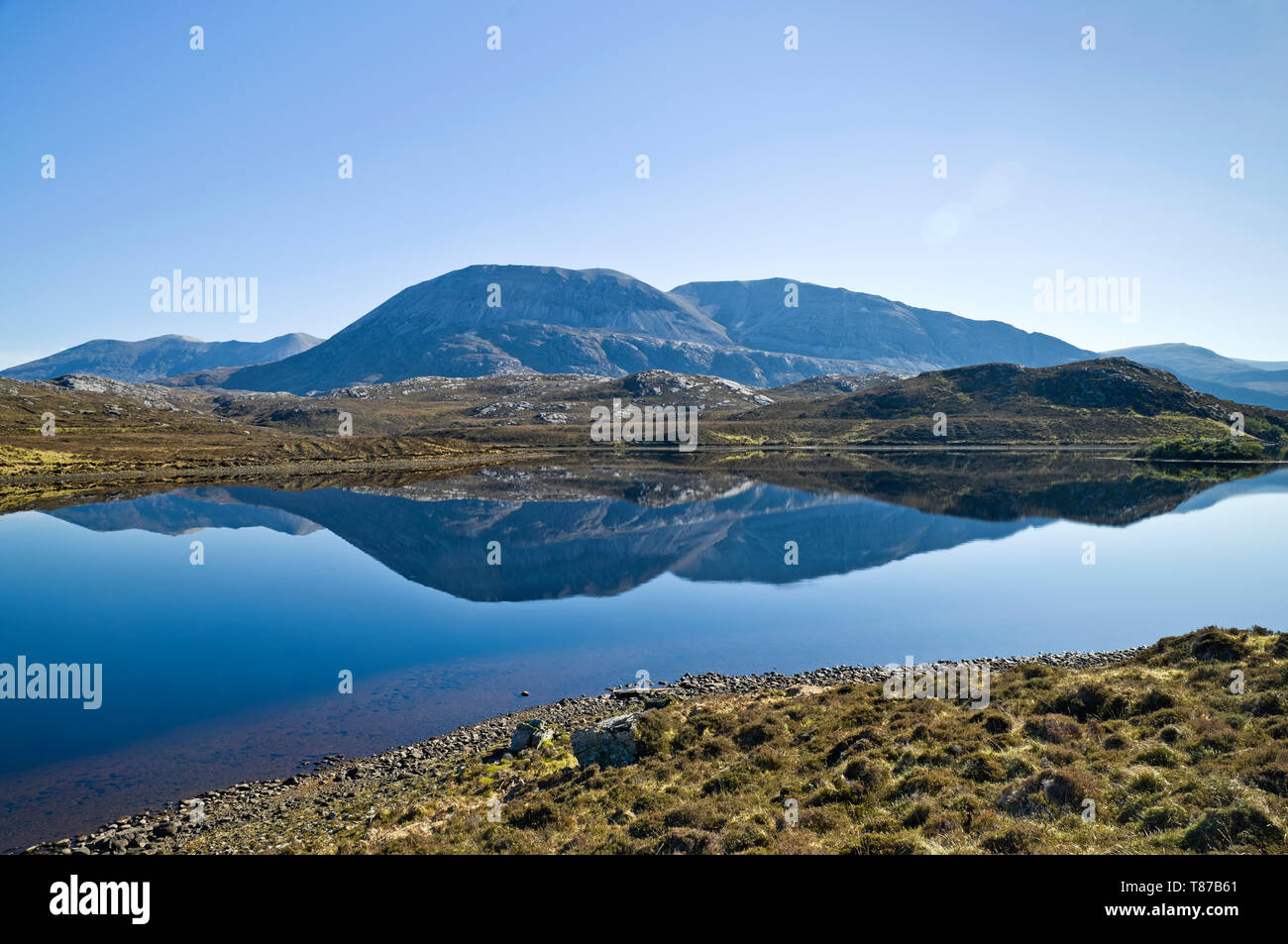 The mountain Arkle reflected in Loch Stack on a calm clear Spring morning, Sutherland, Scottish Highlands, Scotland UK Stock Photo