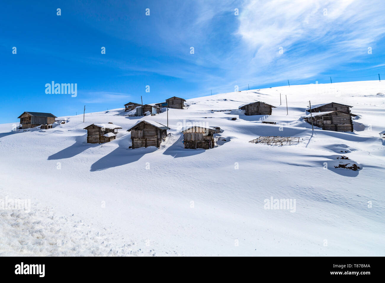 Highland houses and cloudy skies in the snow Stock Photo
