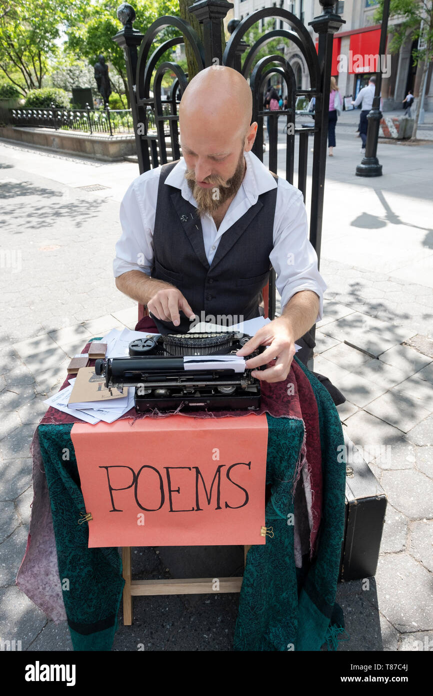 POET FOR HIRE who writes personalized  poems on his typewriter for a fee. In Union Square Park in manhattan, New York City. Stock Photo