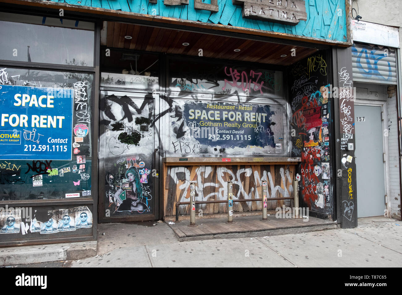 A vacant store for rent on Houston Street in Manhattan covered in graffiti, stickers and tags. Lower East Side, New York City. Stock Photo