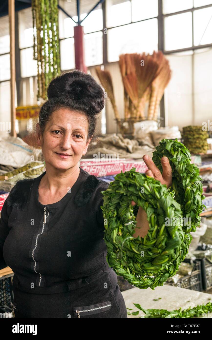 Armenia, Yerevan, G.U.M. Market, food market hall, woman braiding sorrel Stock Photo