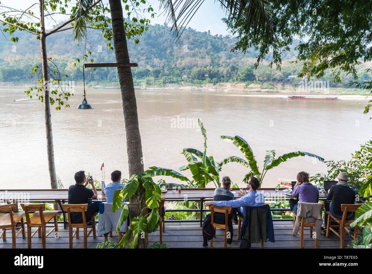 Laos, Luang Prabang, people at Mekong Riverfront cafe Stock Photo