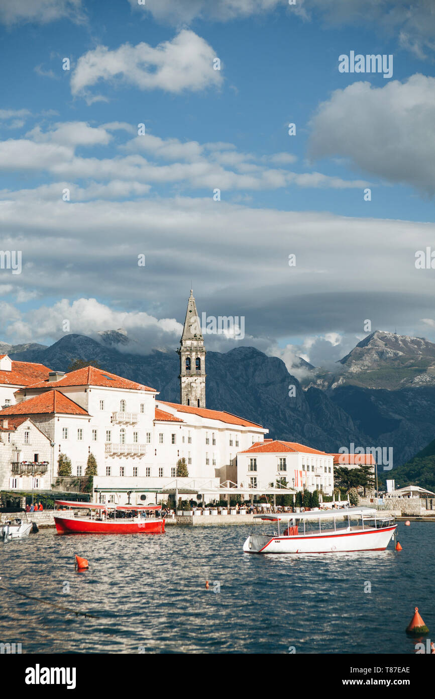 Beautiful view of the old coastal town of Perast in Montenegro with beautiful architecture, the sea and boats on the background of the mountains. Stock Photo