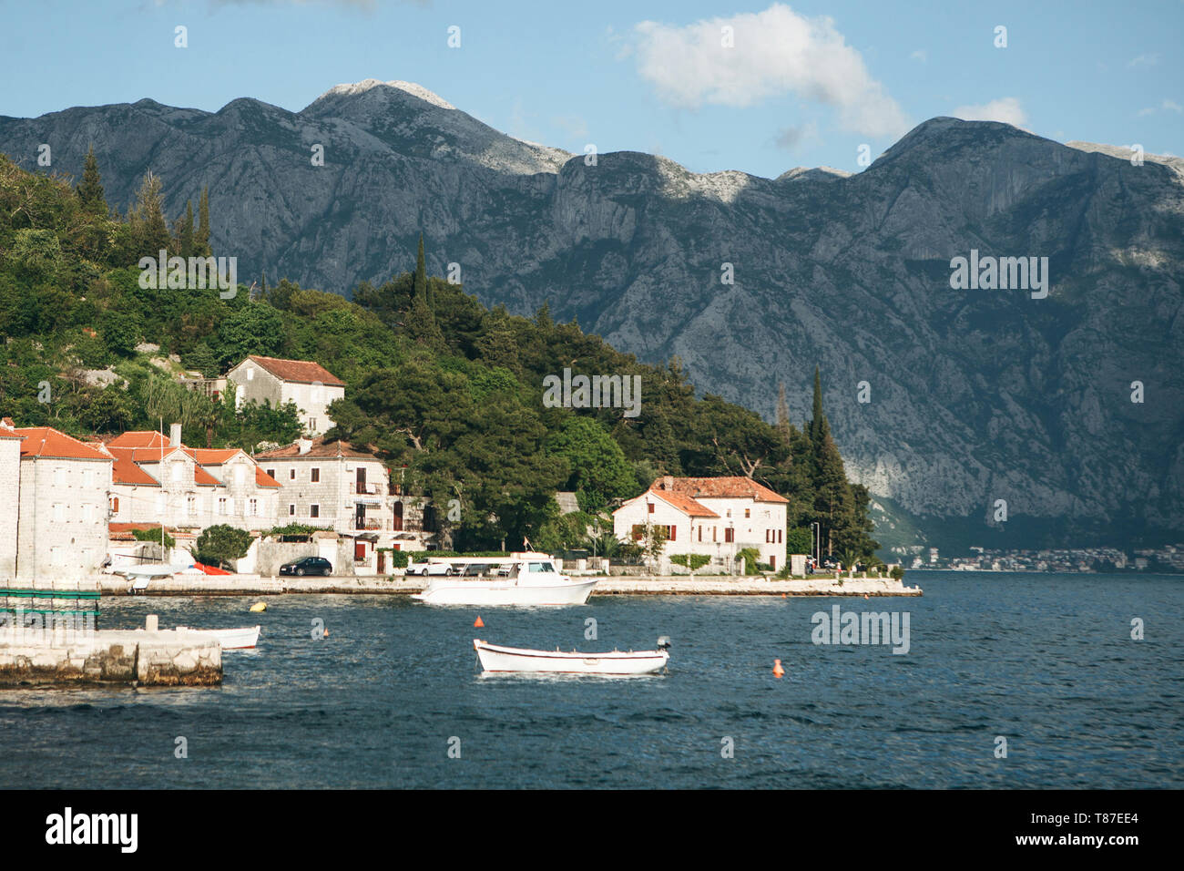 Beautiful view of the old coastal town of Perast in Montenegro with beautiful architecture, the sea and boats on the background of the mountains. Stock Photo