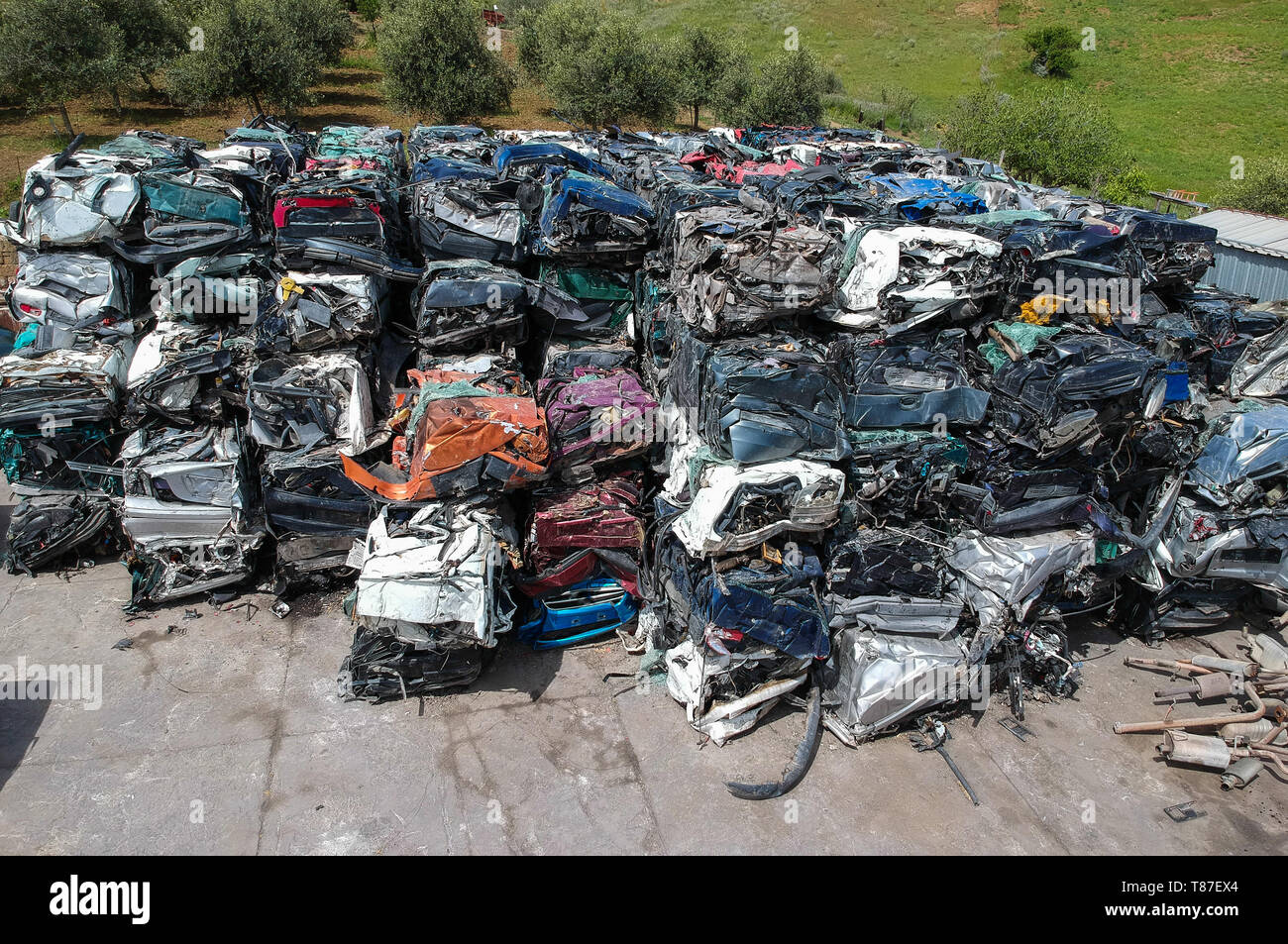 Cars in junkyard, pressed and packed for recycling. Stock Photo