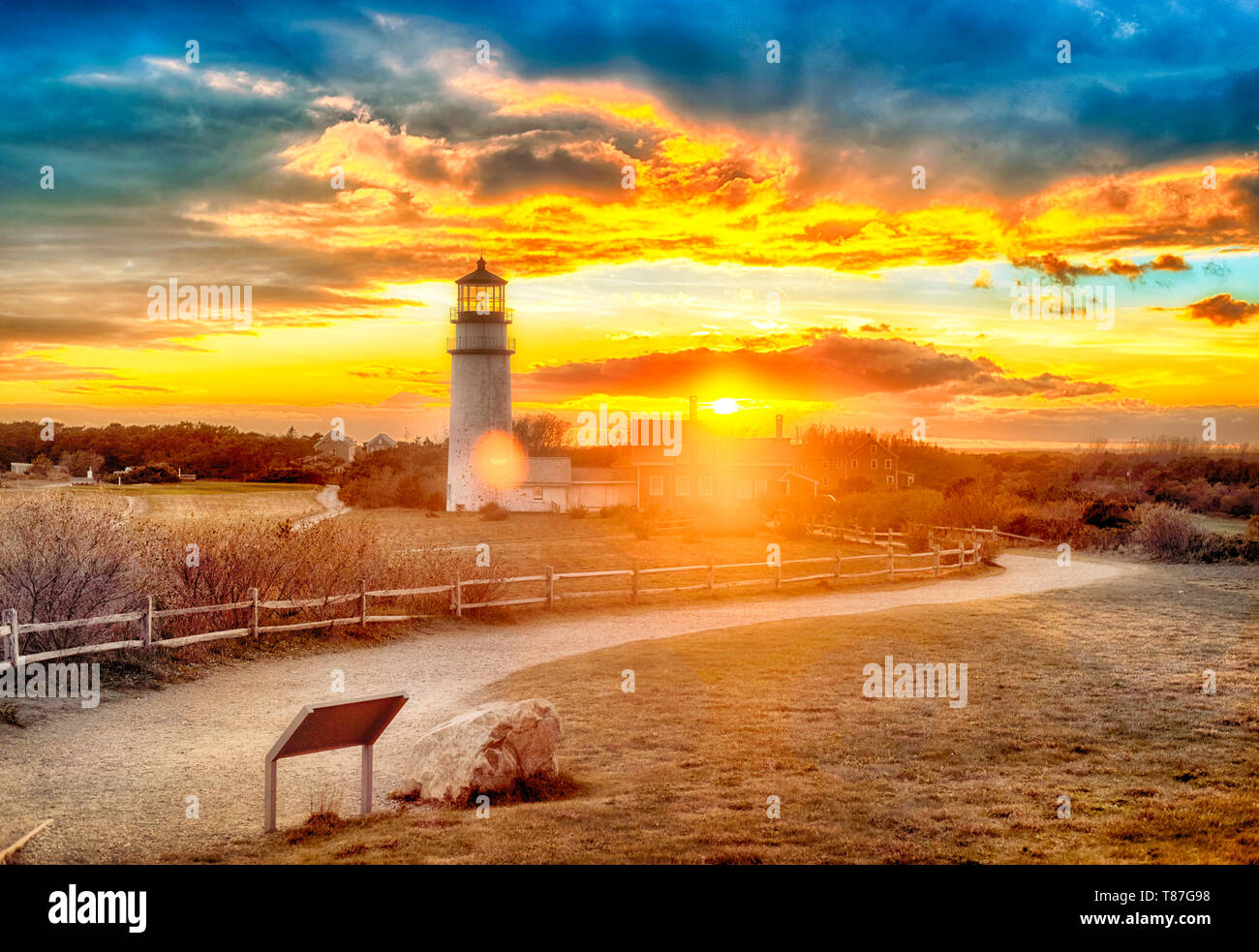 The Highland Lighthouse against a beautiful dramatic sunset in North Truro Massachusetts on the Cape Cod National Seashore. Stock Photo