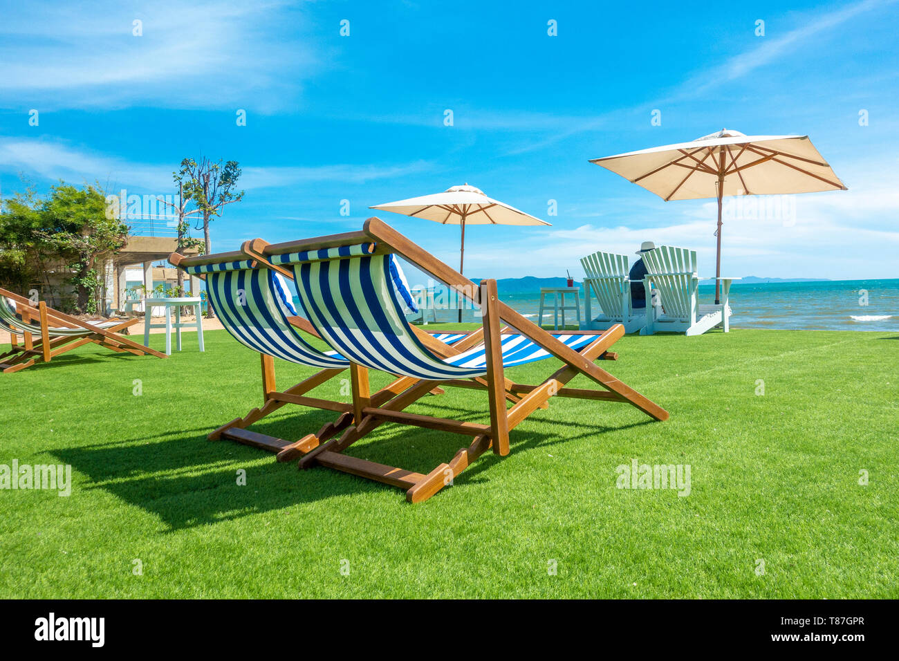 lounge chairs with sun umbrella on a beach Stock Photo Alamy
