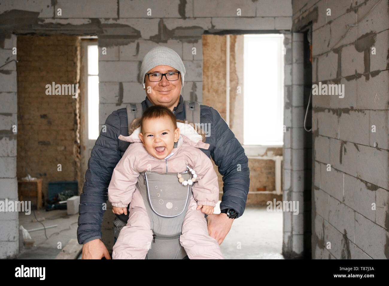 Curated visual reference: Happy Dad And Baby In Carrier In New House On Photo Inspiration