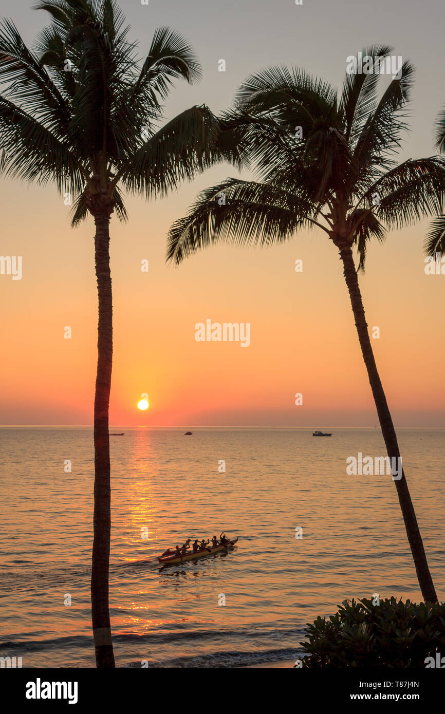 An outrigger heads out for a sunset paddle Stock Photo