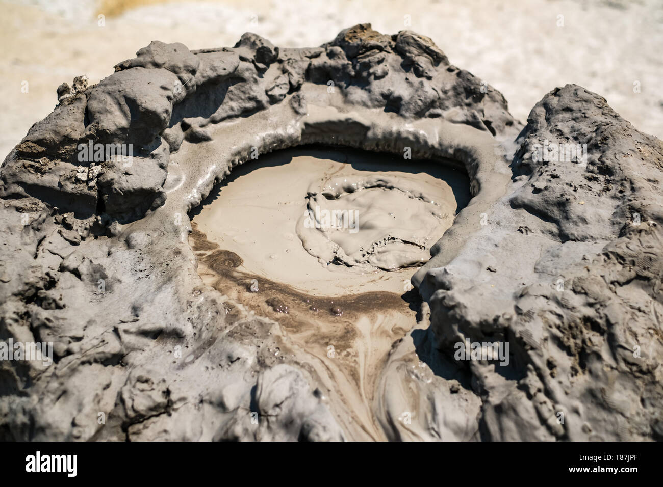 Close-up of bubbling mud in crater of mud volcano in Buzau county, Romania Stock Photo