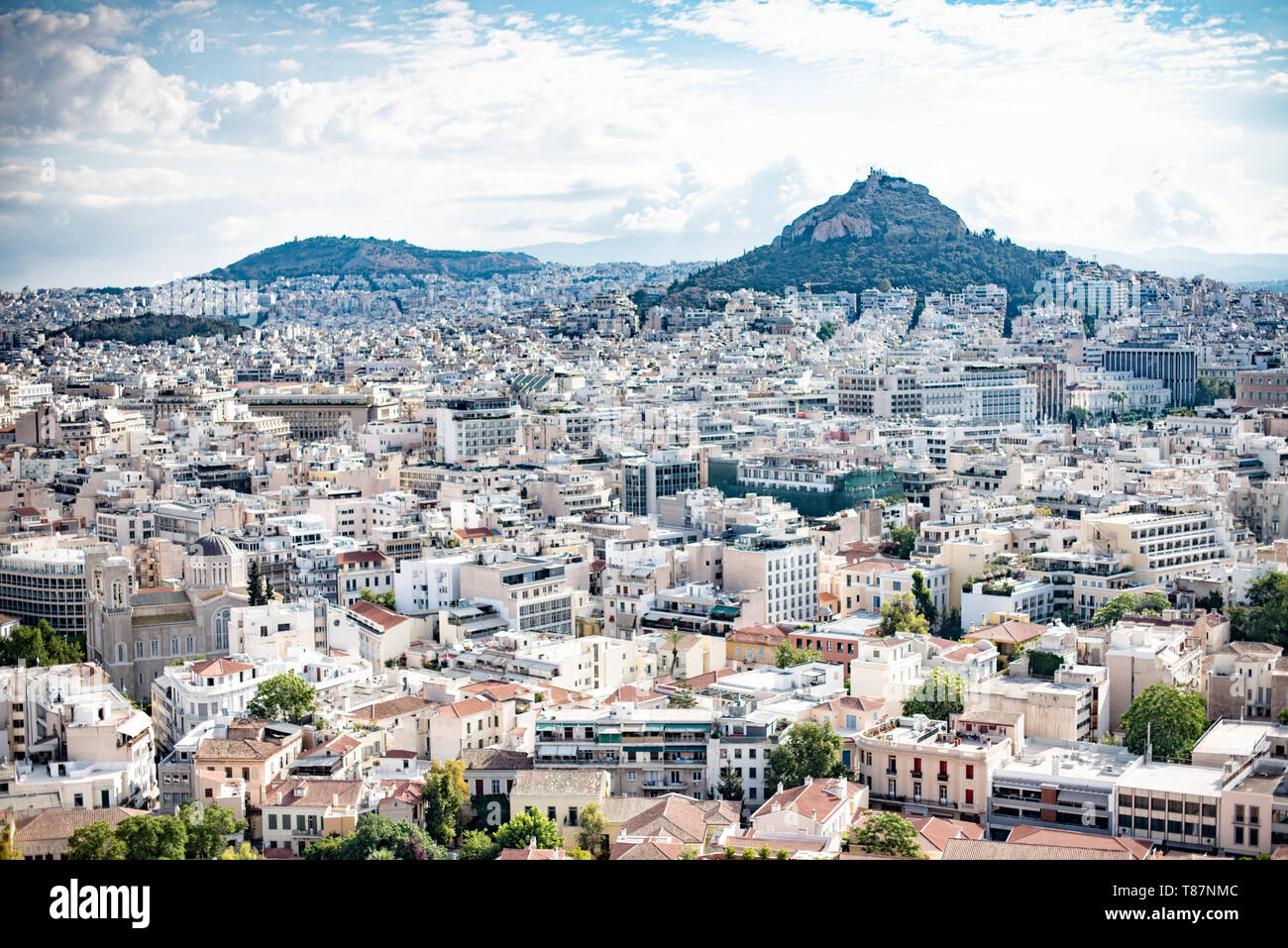 ATHENS, Greece - The Acropolis of Athens is an ancient citadel standing on a rocky outcrop above Athens, Greece. It is one of the most famous archeological sites in the world and is a UNESCO World Heritage site. It consists of a number of structures on the top of the hill, along with other sites on the surrounding hillside. The most famous structure if the Parthenon, a large temple dating back to the 5th century BC and featuring a distinctive outer layer of large columns. Stock Photo