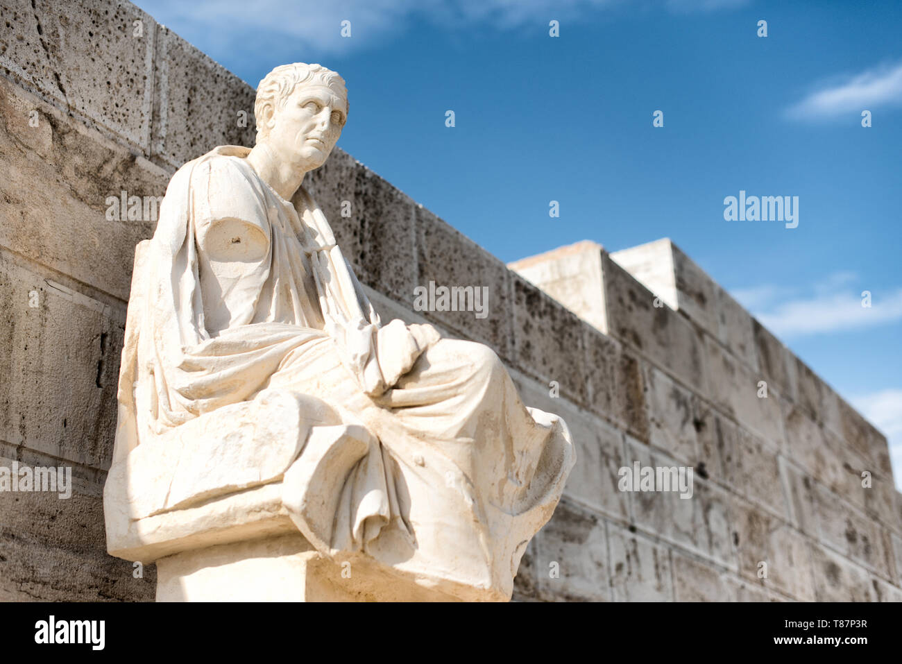 ATHENS, Greece - Honorary monuments of dramatic poets at the eastern parados at the Acropolis. The Acropolis of Athens is an ancient citadel standing on a rocky outcrop above Athens, Greece. It is one of the most famous archeological sites in the world and is a UNESCO World Heritage site. It consists of a number of structures on the top of the hill, along with other sites on the surrounding hillside. The most famous structure if the Parthenon, a large temple dating back to the 5th century BC and featuring a distinctive outer layer of large columns. Stock Photo