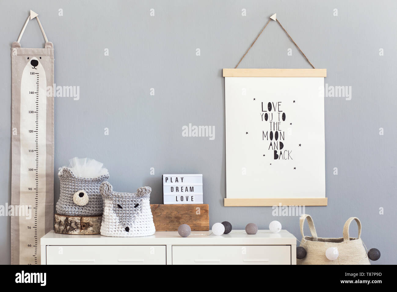 Stylish and modern scandinavian nursery interior with gray walls, brown