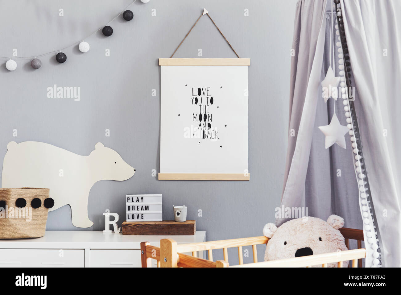Stylish and modern scandinavian nursery interior with gray walls, brown