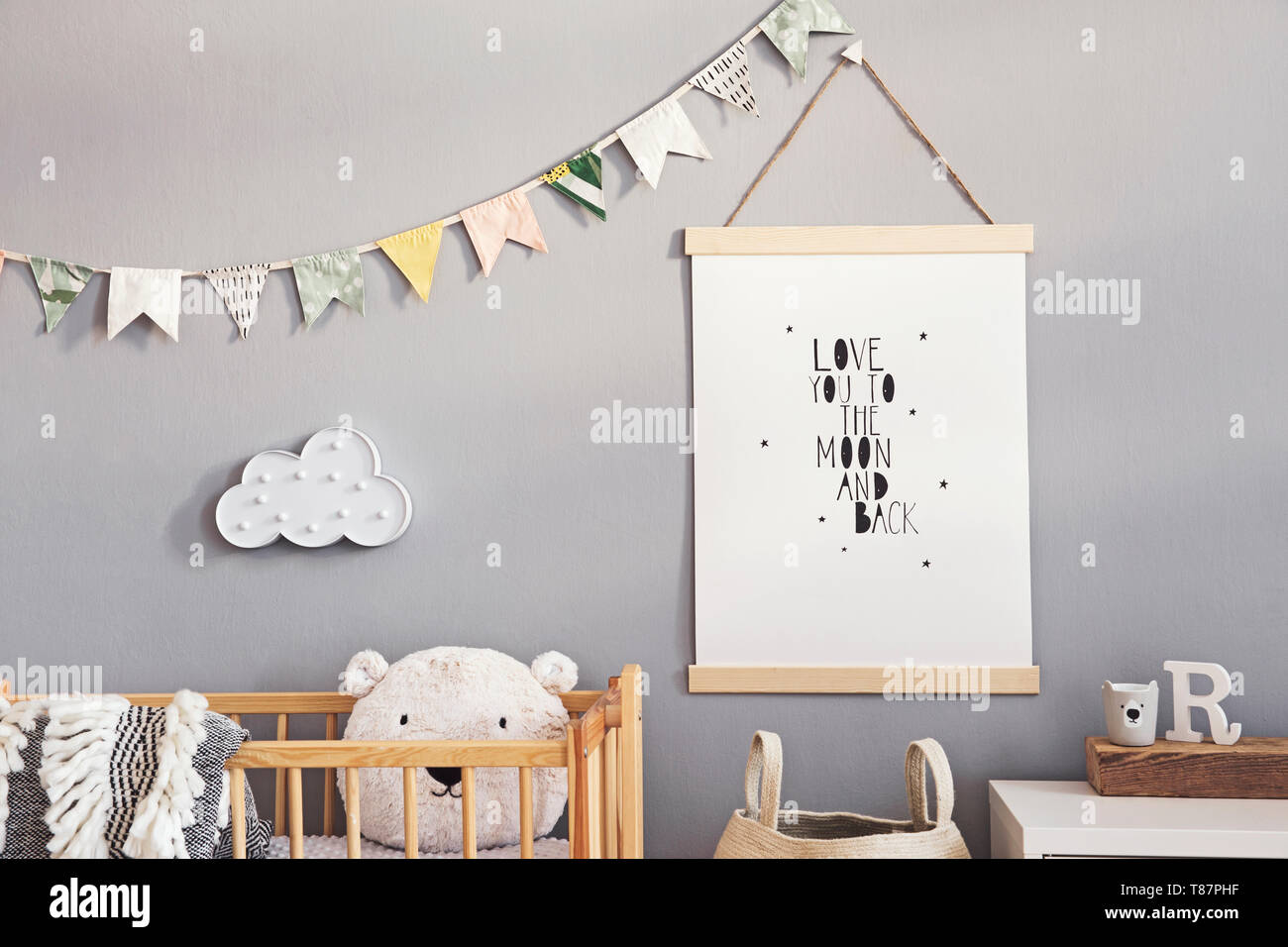 Stylish and modern scandinavian nursery interior with gray walls, brown