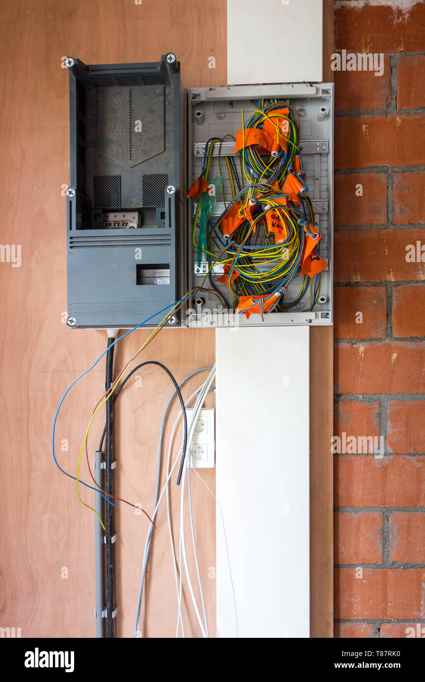 Electric wires / electrical cables / wiring in new fuse box in newly built house under construction Stock Photo