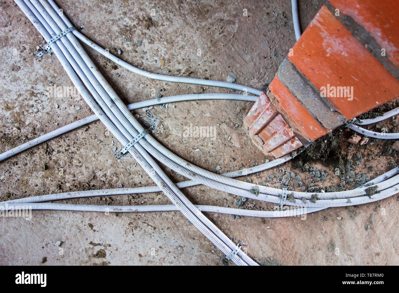 Electric wires / electrical cables / wiring fixed on the floor in newly built house under construction Stock Photo