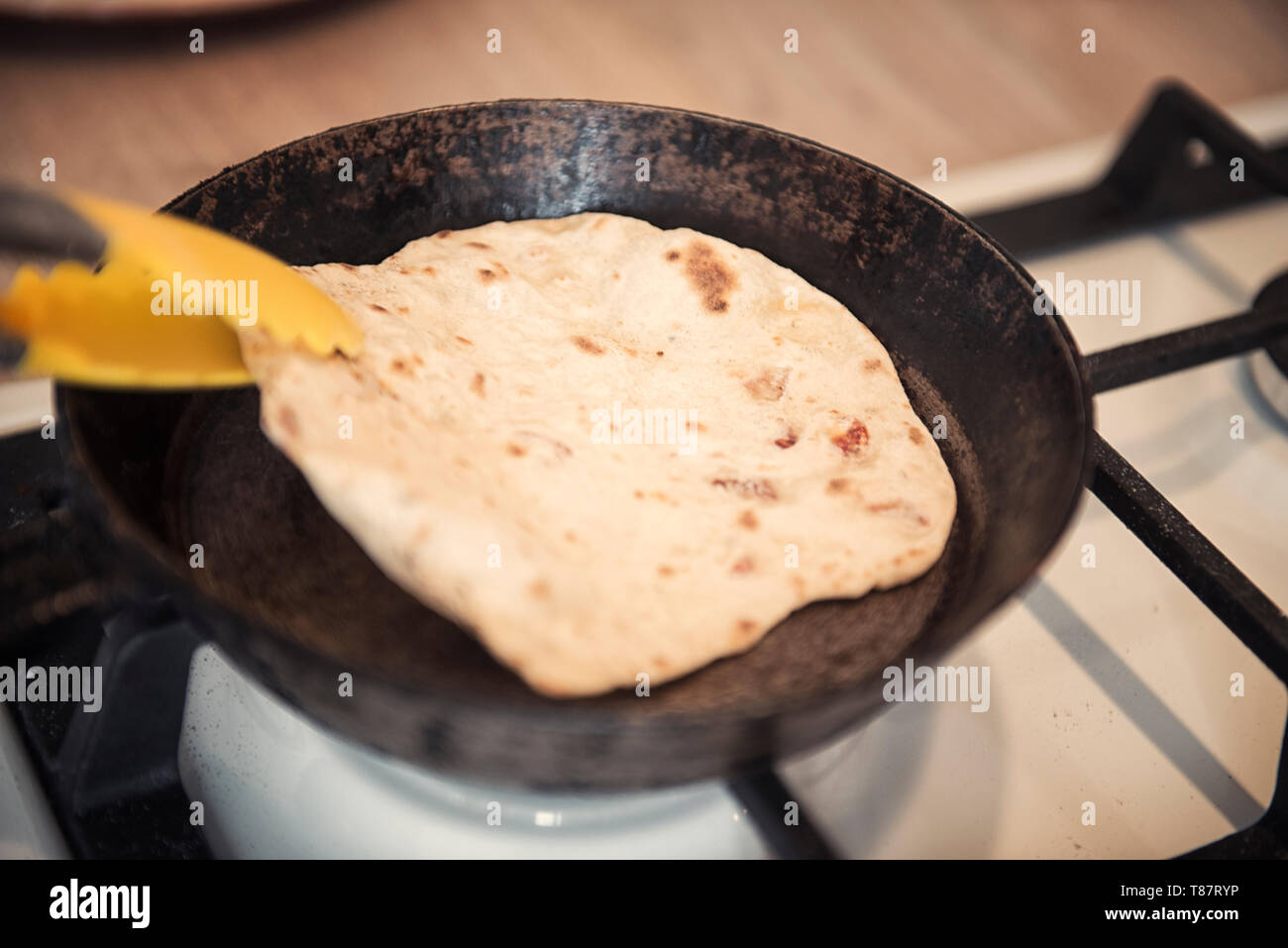 Greek pita bread on the old skillet Stock Photo Alamy
