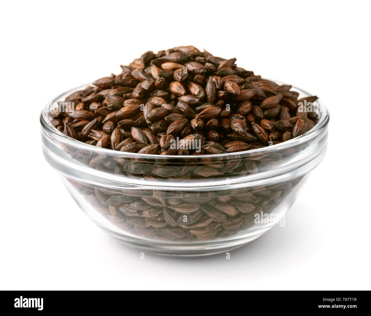 Glass bowel of dark malted barley isolated on white Stock Photo