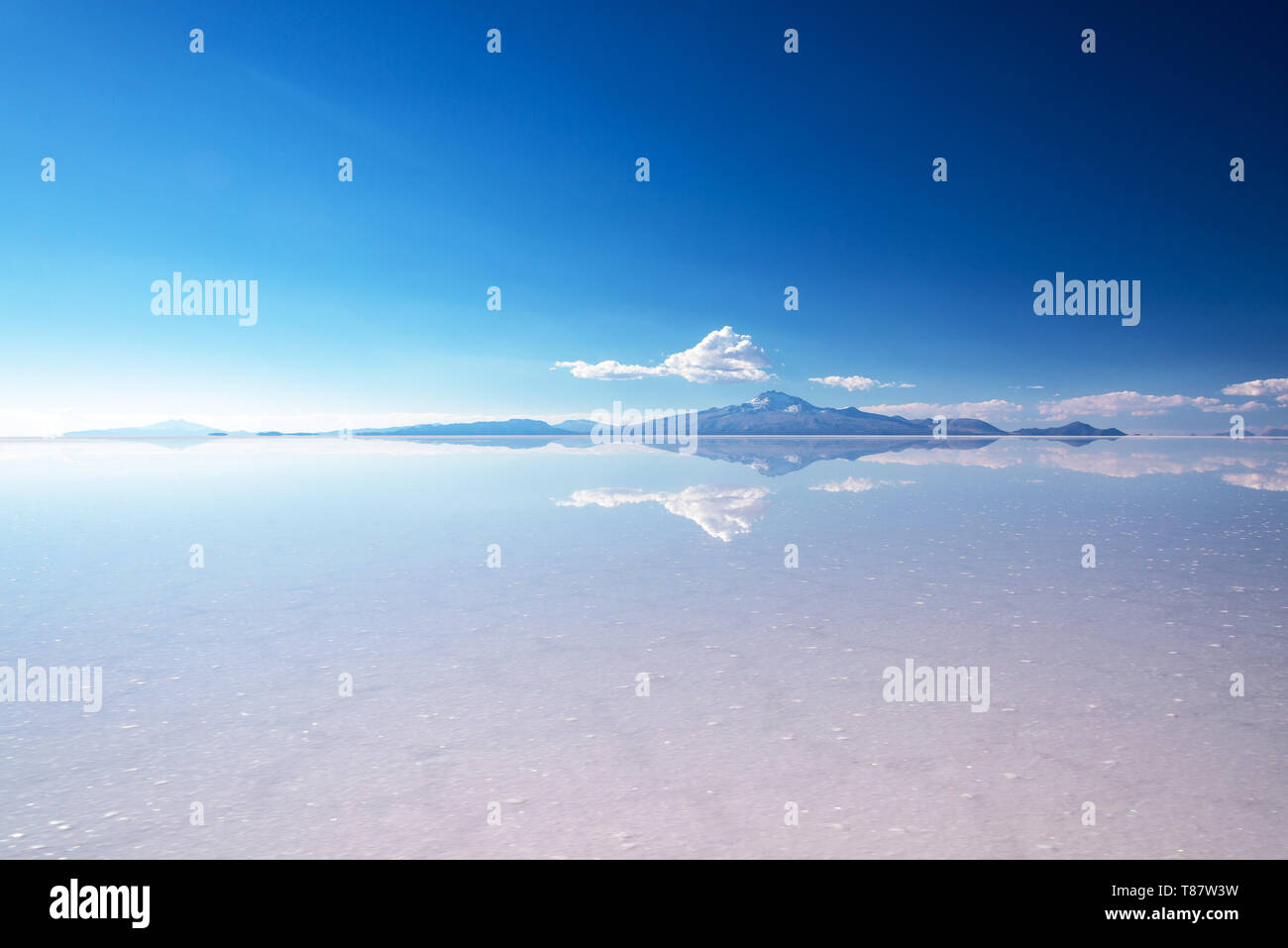 Miror effect and reflection of mountain in Salar de Uyuni (Uyuni salt flats), Potosi, Bolivia, South America Stock Photo