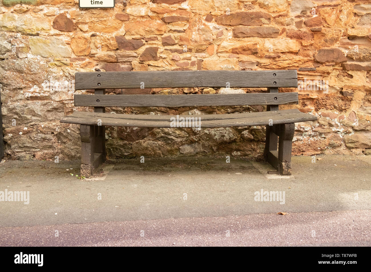 Worn Bent Empty Wooden Bench In The Village Of Cockington Devon