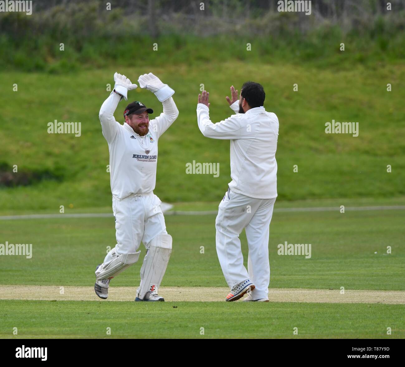 Wicket keeper celebrates a wicket with the bowler in the match between