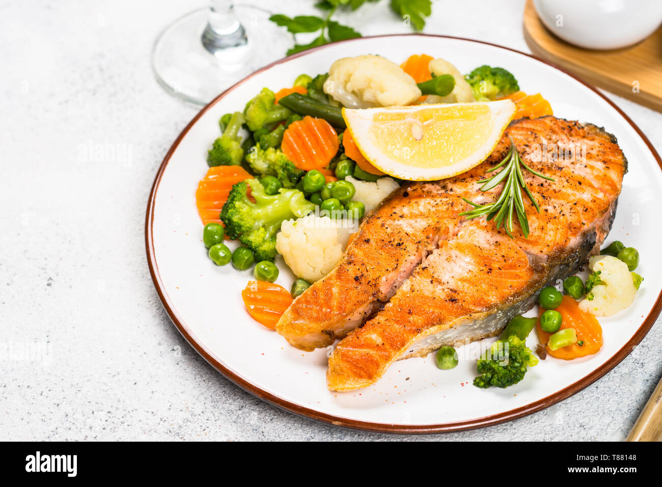 Grilled salmon steak with vegetables on white Stock Photo - Alamy
