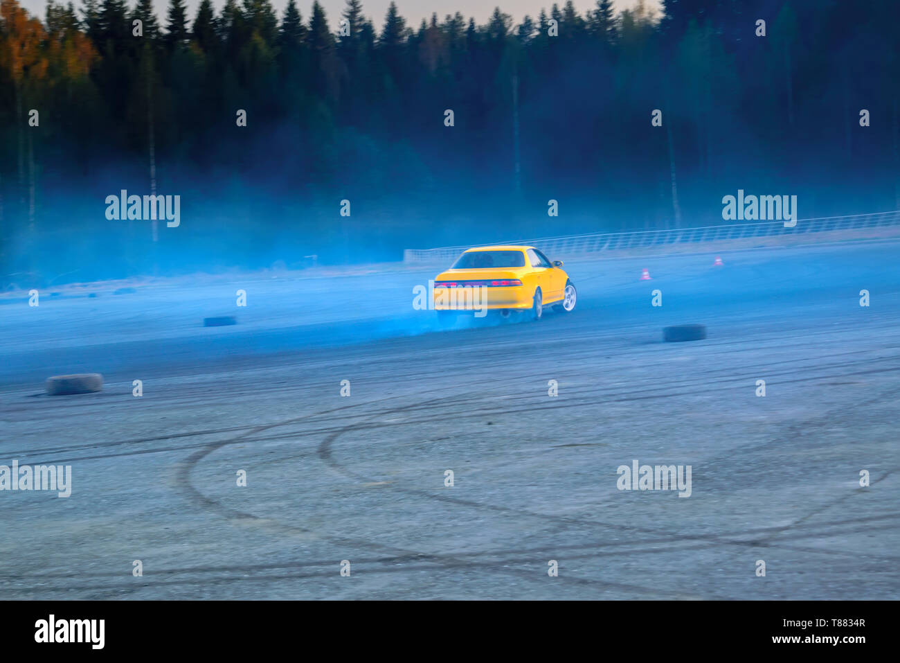 Car drifting, Blurred of image diffusion race drift car with lots of smoke from burning tires on speed track Stock Photo